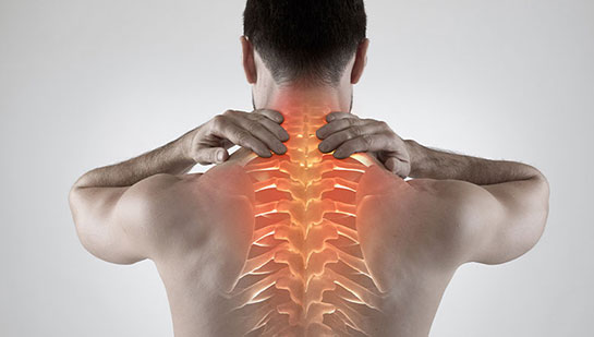 Man with upper back pain before chiropractic treatment from Buckeye chiropractor