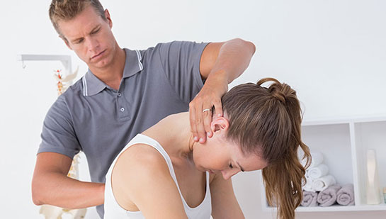 Woman receiving chiropractic adjustment from a Goodyear chiropractor