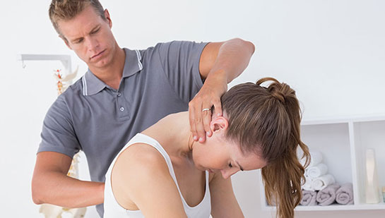 Woman receiving chiropractic adjustment from a Phoenix chiropractor