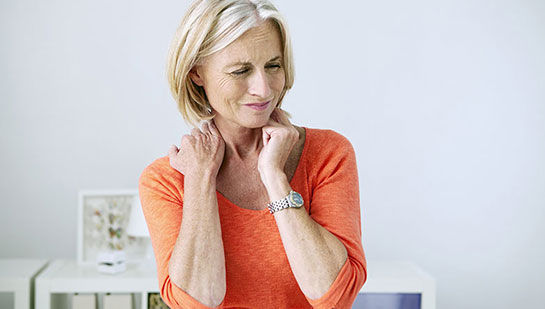 Mature woman suffering from neck and shoulder pain before visiting Phoenix chiropractor