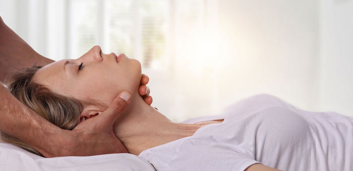 Woman receiving neck adjustment from Phoenix chiropractor