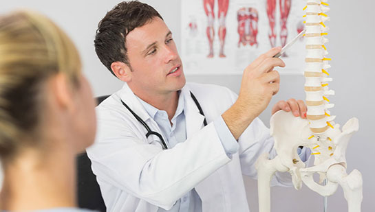 Phoenix chiropractor explaining spine misalignments to patient