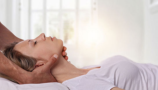 Woman receiving neck adjustment from Laveen chiropractor